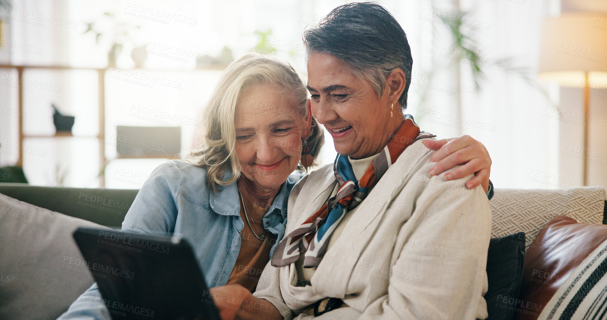 Buy stock photo Tablet, mature and lesbian couple on sofa with smile, watch movie and bonding together on weekend. Happy, lgbt people and relax in living room with tech, healthy relationship and online film in home.
