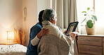 Caregiver, support and old woman in nursing home with picture frame, bonding or memories of marriage. Back, senior person and nurse in retirement center with photo, comfort or nostalgia for loved one