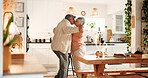 Dancing, kiss and senior couple in kitchen, romance and retirement fun for anniversary celebration. Home, bonding and elderly people with affection for healthy relationship, marriage support and love