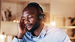 Tired, black man and consultant with headset in home for fatigue, overtime or late evening. Male person, freelance agent or employee working at night with stress for burnout or pressure in house
