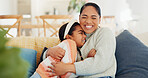 Mother, child and hug on sofa with smile, connection and love for bonding together on weekend break. Happy, woman and daughter embrace in home with kindness, wellness and support for development.