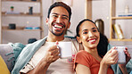 Laugh, couple or watching tv with coffee on sofa for comedy movie, weekend entertainment or bonding. Beverage, happy people and streaming with blanket in home for funny series, comic show or security