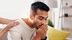Hands, support and man with grief in home, heartbroken or thinking of divorce on sofa in living room. Comfort, help and person with depression after separation, reflection and sad memories in house