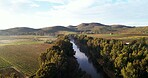 River, above and countryside with nature, mountains and blue sky with trees, sunshine and agriculture. Empty, clouds and landscape with lake, summer break and growth with view and sustainability
