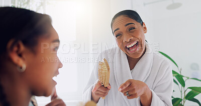 Buy stock photo Hair care, mother and girl in bathroom, singing and bonding together with happiness. Home, people and mama with daughter, brush and dancing for fun, relax and playful with smile, energy and grooming
