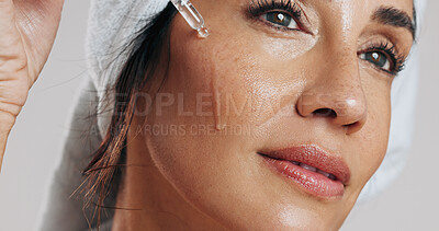 Buy stock photo Skincare, thinking or woman with serum in studio, apply hyaluronic acid or anti aging facial treatment. Dropper, dermatology or mature person with product for glowing skin, vision or white background