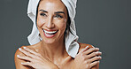 Shine, woman and skincare in studio for anti aging, confidence and aesthetic in dermatology. Mature person, treatment and towel with cosmetology, beauty or cosmetics with space on gray background