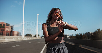Buy stock photo City, runner and black woman with smart watch for exercise, health app and fitness tracker in street. Sports, space and person check time for training, workout progress and active hobby in town
