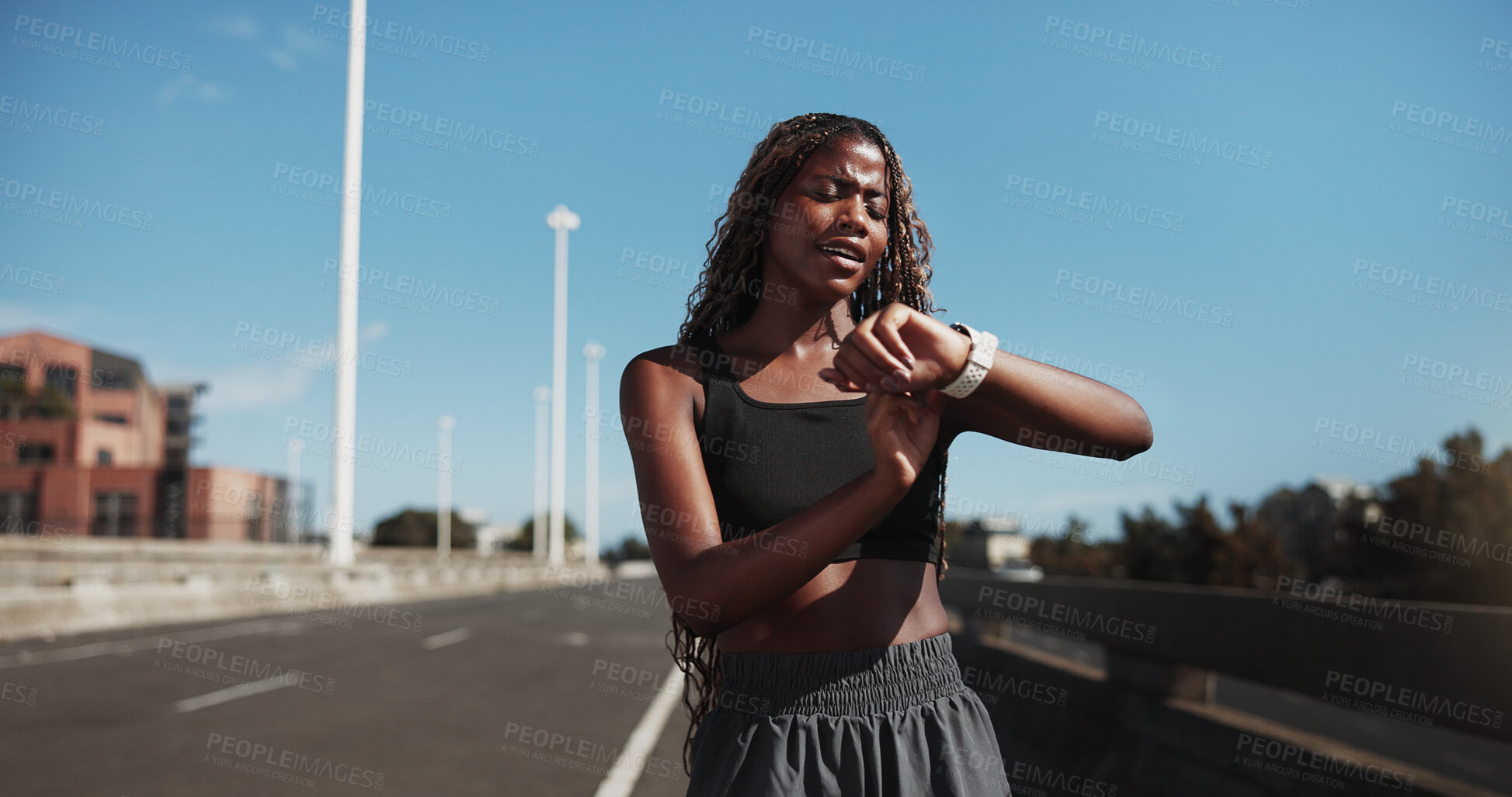 Buy stock photo City, runner and black woman with smart watch for exercise, health app and fitness tracker in street. Sports, space and person check time for training, workout progress and active hobby in town