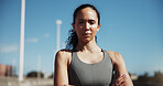 Fitness, portrait or woman in city with arms crossed, pride or rest after physical activity. Sports, serious or female person outdoor with confidence, active hobby or performance break in New Zealand