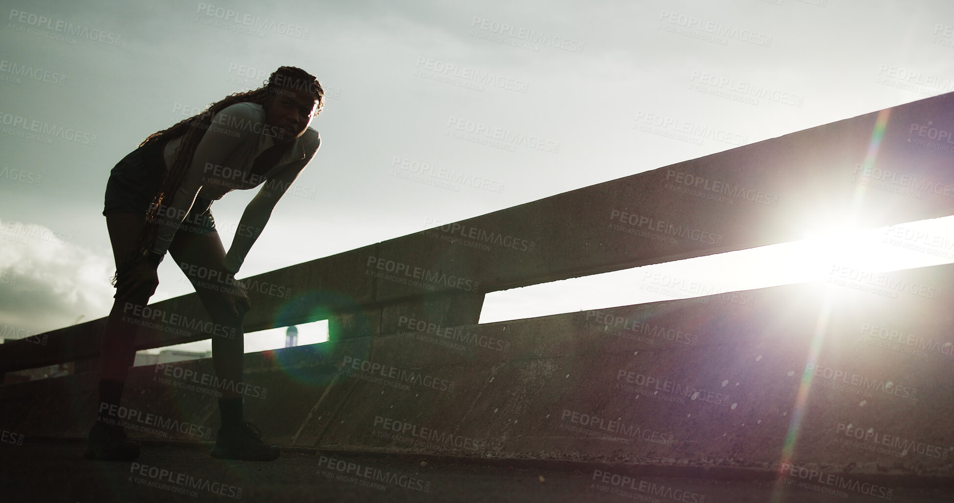 Buy stock photo Athlete, tired and woman with breathing in city for cardio burnout, intense exercise or recovery. Flare, fitness or exhausted person on bridge for running fatigue, endurance challenge or workout rest