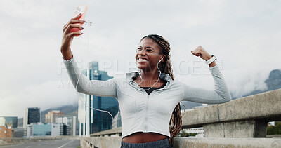 Buy stock photo Exercise, selfie and black woman in city with win, cardio workout or smile with music. Fist pump, earphones or runner celebrate for wellness, sports and playlist outdoor with fitness photography