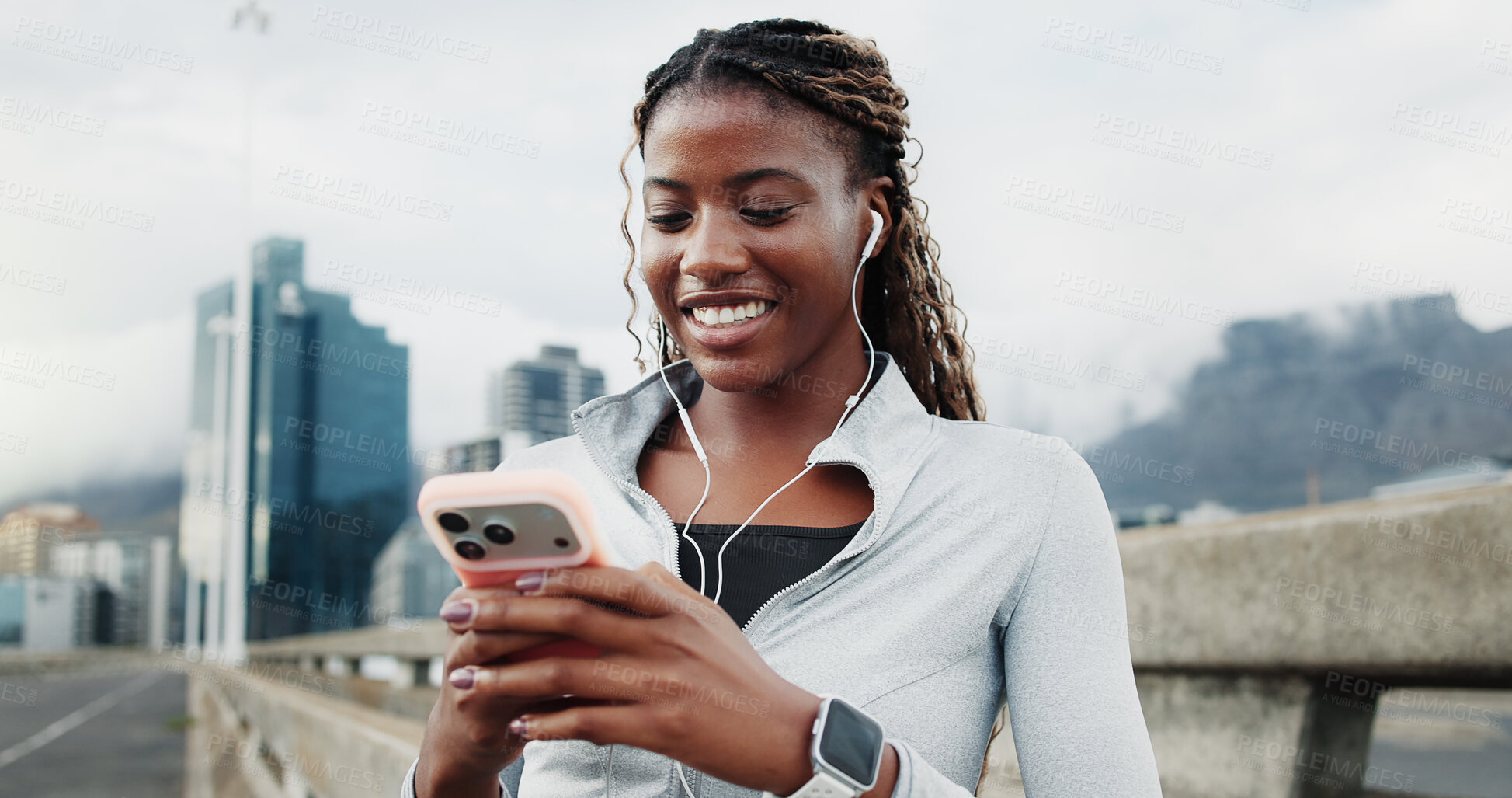 Buy stock photo Athlete, earphones and happy woman with smartphone on bridge, browsing and listening to music on web. City, scroll and black person with mobile for chat, fitness and streaming audio on workout break