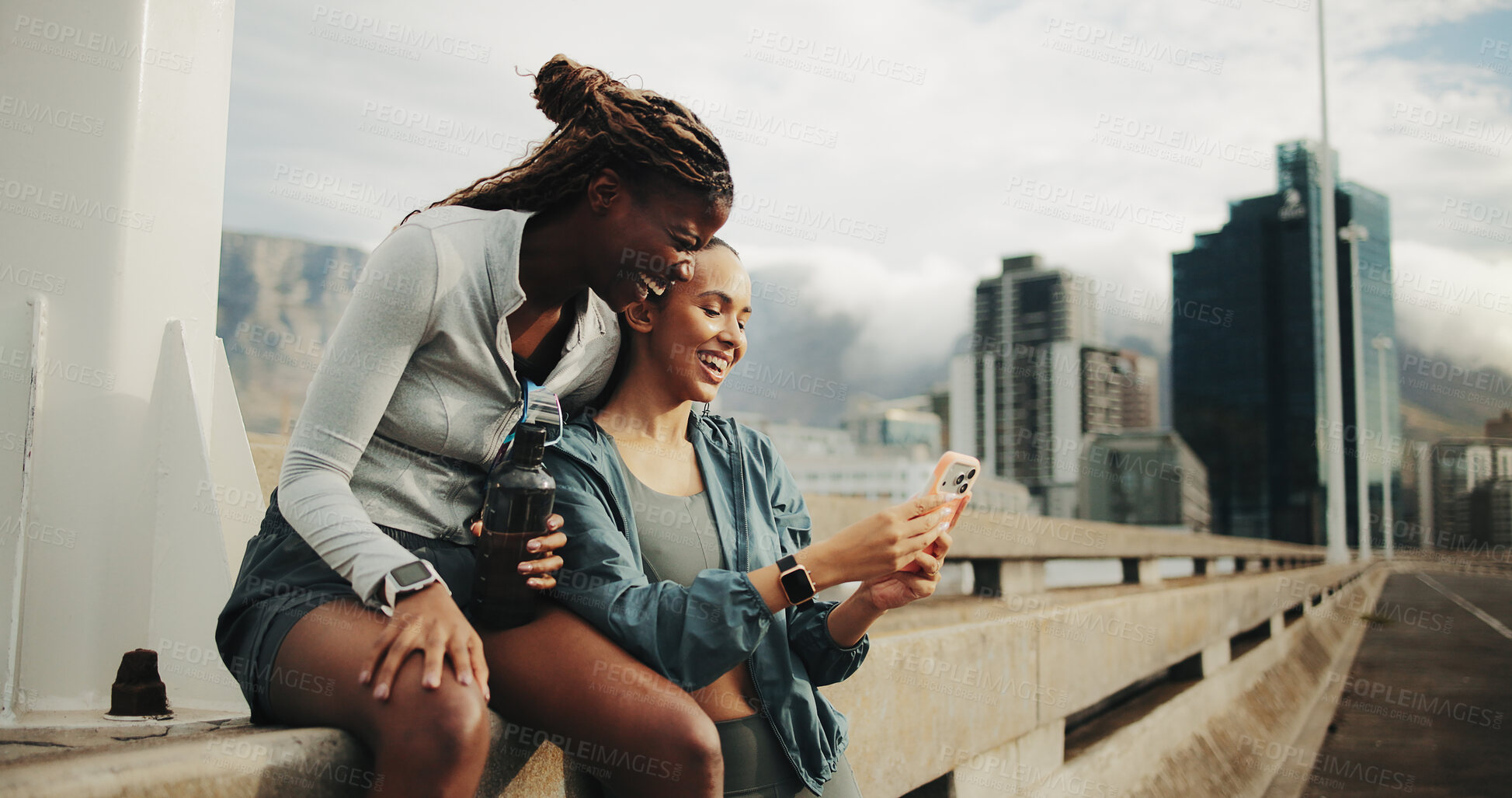 Buy stock photo Women, friends and phone for fitness, break and laugh for outdoor training on street. City bridge, social media post and people with exercise for health rest, support or marathon practice together