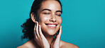 Skincare, beauty and woman with smile in studio, wellness glow aesthetic and touch for smooth texture. Facial shine, dermatology or happy person with space for soft skin, self care or blue background