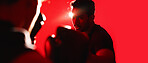 Boxing, fitness and man in studio with gloves for training, workout or wellness with energy. Banner, sports and athlete with fight challenge for cardio exercise, health or practice by red background.