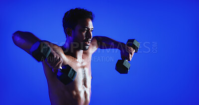 Buy stock photo Fitness, weight training or man in studio with dumbbell, power or bicep lift in bodybuilding. Exercise, space or person on blue background with equipment, intense workout or strength in muscle gain.