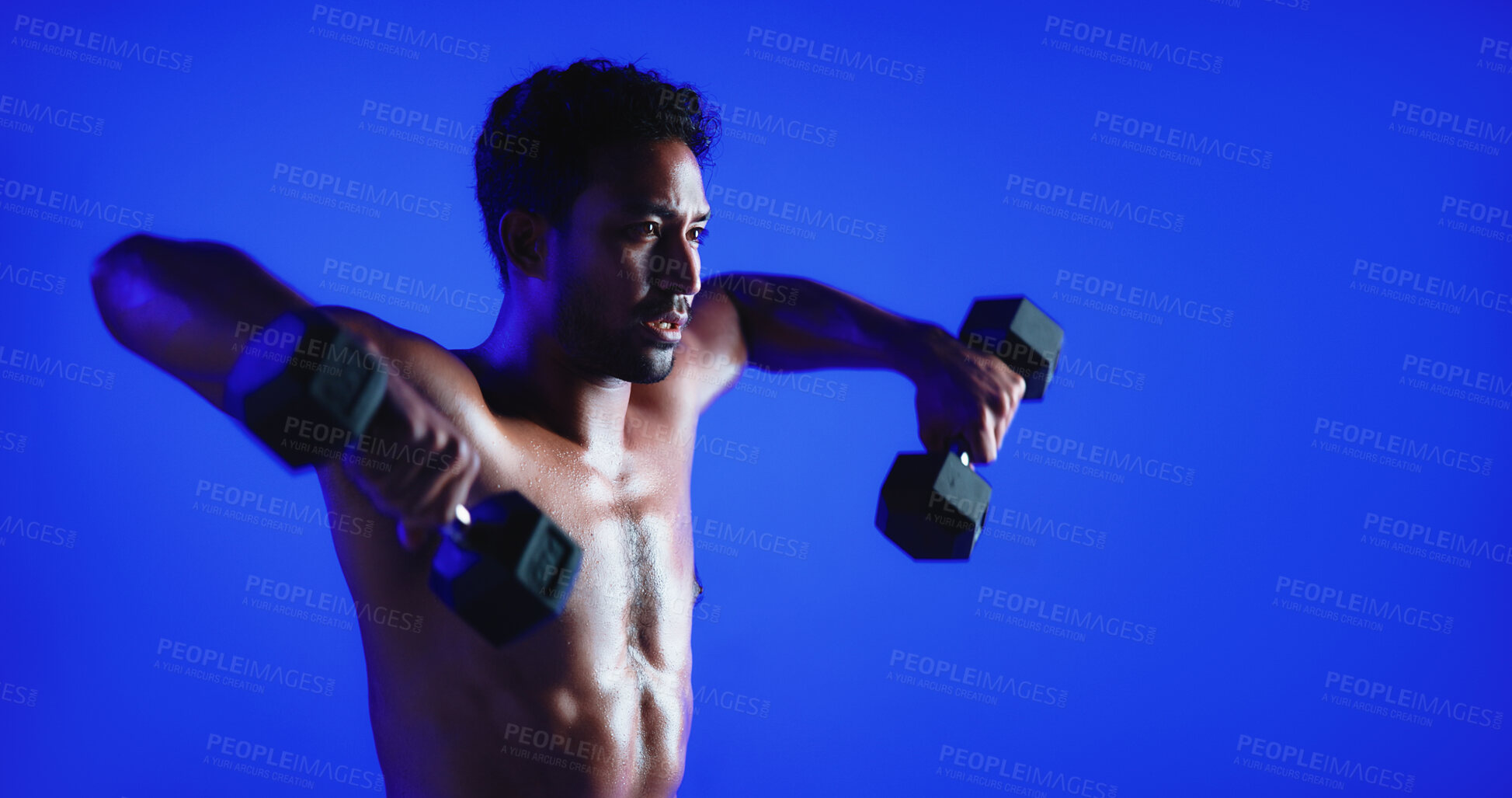 Buy stock photo Fitness, weight training or man in studio with dumbbell, power or bicep lift in bodybuilding. Exercise, space or person on blue background with equipment, intense workout or strength in muscle gain.