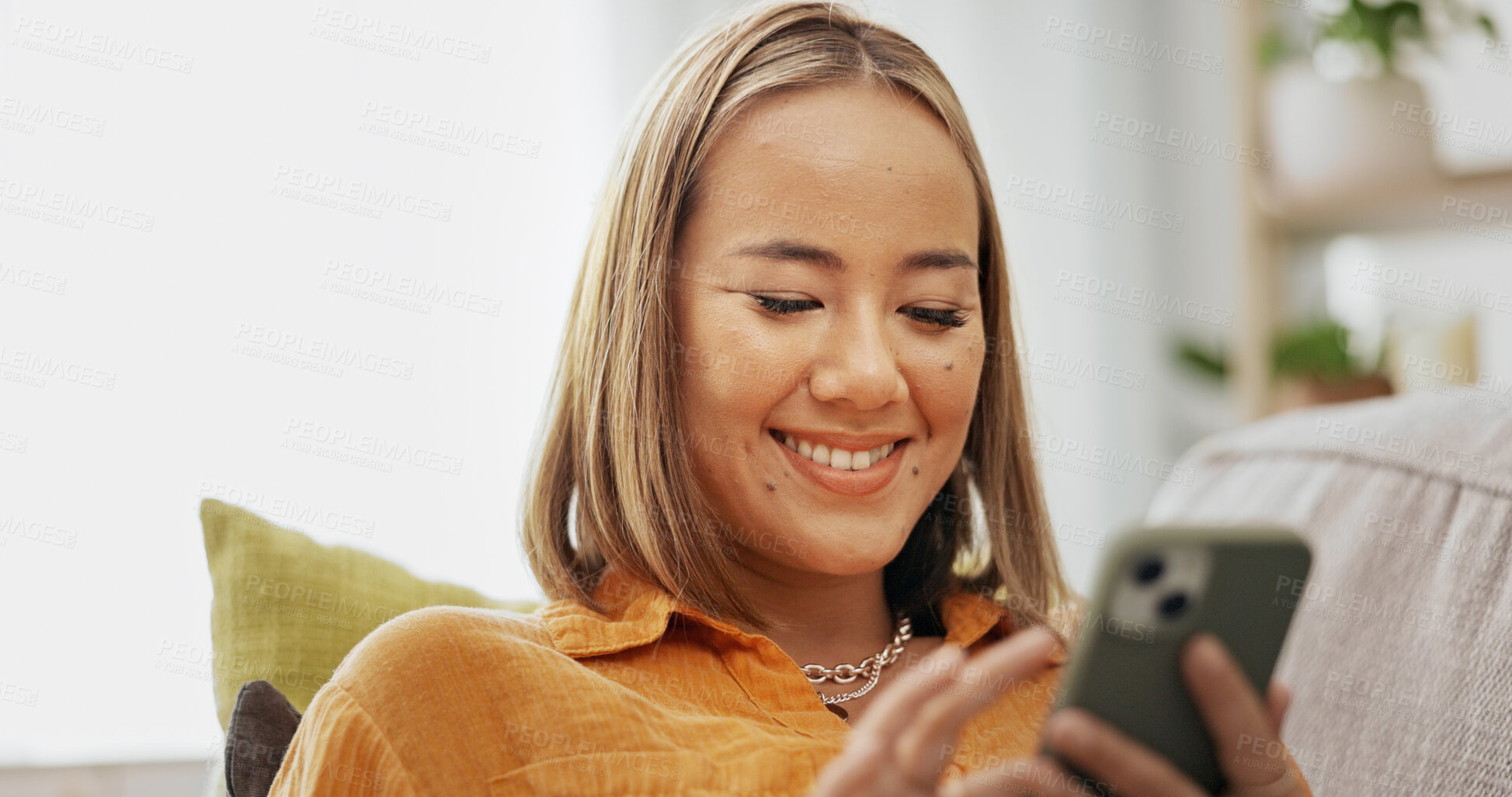 Buy stock photo Woman, phone and smile on sofa with social media, communication and networking in living room. Gossip, female person and reading with digital tech for online chatting, texting or mobile app in house