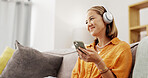 Chill, phone or Asian woman in house with headphones, song connection or listening to music playlist. Relax, smile or person in living room with tech, podcast or radio subscription on audio app.
