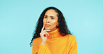 Thinking, vision and question with woman in studio for problem solving, reflection and future. Planning, idea and perspective with person on blue background for brainstorming, decision and insight