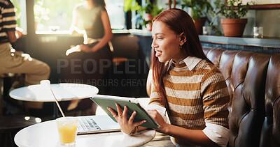 Buy stock photo Laptop, remote work and tablet with woman in coffee shop for journalism, planning or research. App, reading and technology with freelance journalist in restaurant booth for editing or publishing