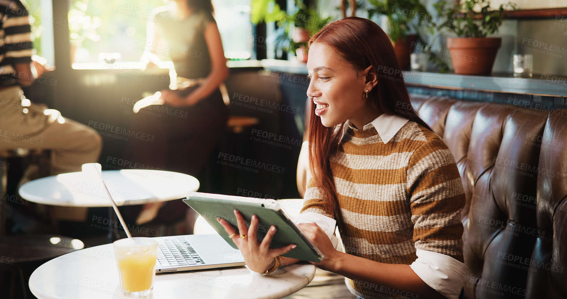 Buy stock photo Laptop, remote work and tablet with woman in coffee shop for journalism, planning or research. App, reading and technology with freelance journalist in restaurant booth for editing or publishing