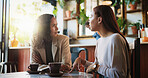 Business, meeting and talking with women in coffee shop together for project management or update. Collaboration, conversation and feedback with employee people in cafe for discussion or teamwork