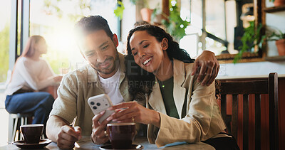 Buy stock photo Happy couple, hug and phone at coffee shop on date with bonding, love and care with meme at diner. Woman, man and relationship with smartphone, embrace or mobile app with social media at restaurant