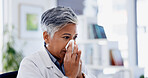 Sick, tissue and businesswoman blowing nose in office with  cold, flu or sinus infection. Illness, virus and mature female person with toilet paper for sneeze with allergies or hayfever in workplace.