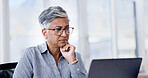 Serious, reading and businesswoman with laptop in office, glasses and financial analysis on website. Business, bookkeeper and mature person with tech for tax preparation, online and research on app