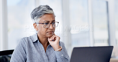 Buy stock photo Serious, reading and businesswoman with laptop in office, glasses and financial analysis on website. Business, bookkeeper and mature person with tech for tax preparation, online and research on app