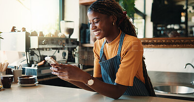 Buy stock photo Waitress, smile and woman in cafe with phone, typing text message or notification for online order. Happy, black person and scroll in coffee shop with tech, social media or mobile app for hospitality