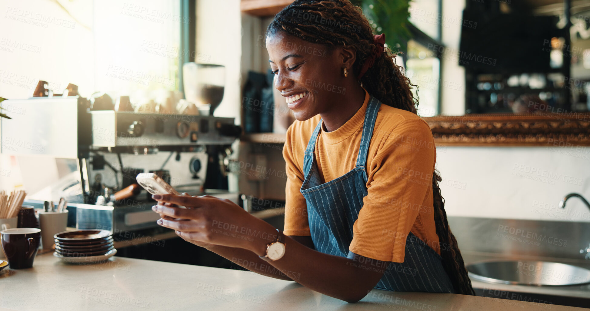 Buy stock photo Waitress, smile and woman in cafe with phone, typing text message or notification for online order. Happy, black person and scroll in coffee shop with tech, social media or mobile app for hospitality