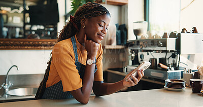 Buy stock photo Text, reading and barista in cafe with phone, chat or social media update on work break. Message, digital or black woman in restaurant with tech, business review or online communication in free time.
