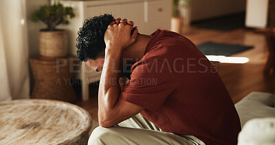 Buy stock photo Sad, thinking and man with depression, mental health and remember memories of sorrow alone in lounge. Frustrated, reflection and upset person with anxiety, stress or overwhelmed with regret in house.