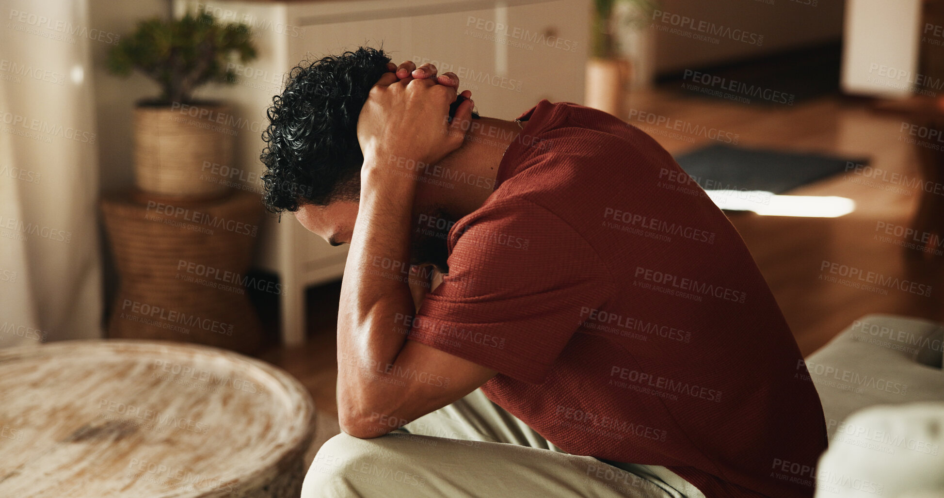 Buy stock photo Sad, thinking and man with depression, mental health and remember memories of sorrow alone in lounge. Frustrated, reflection and upset person with anxiety, stress or overwhelmed with regret in house.