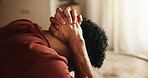 Frustrated, thinking and man with depression, stress and remember memories of sorrow in living room. Lonely, reflection and person with anxiety, mental health and contemplation for regret in house.