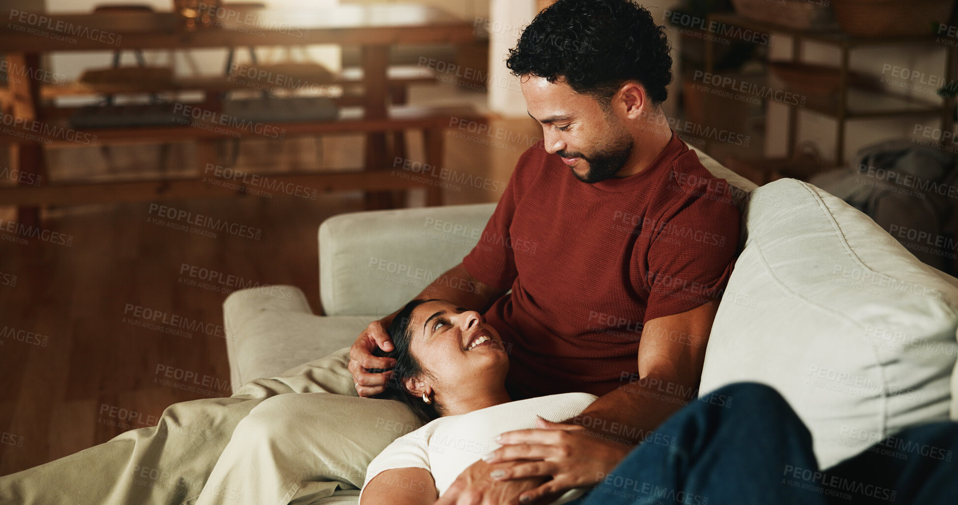 Buy stock photo Happy, couple and relax on sofa with love, romantic connection and bonding together on weekend break. People, smile and rest in home with marriage commitment, loyalty and care for partner in lounge.