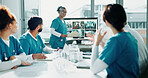 Doctor, presentation and talk in hospital with screen, pointing and lung x ray for medical research. Healthcare worker, people and workshop with monitor, anatomy scan and training team for surgery.