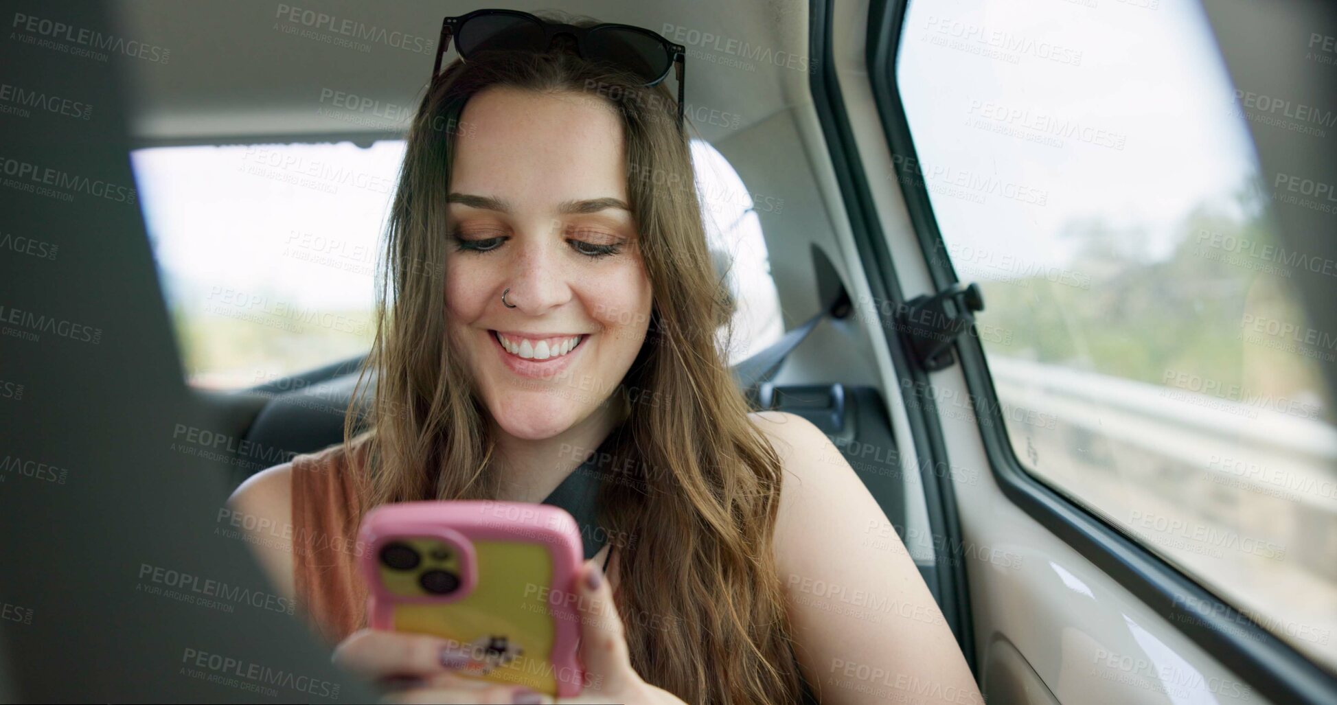 Buy stock photo Passenger, woman and phone in car with smile, travel vacation or social media post for weekend break. Happy, person and journey in vehicle with tech, holiday adventure and check website for road trip