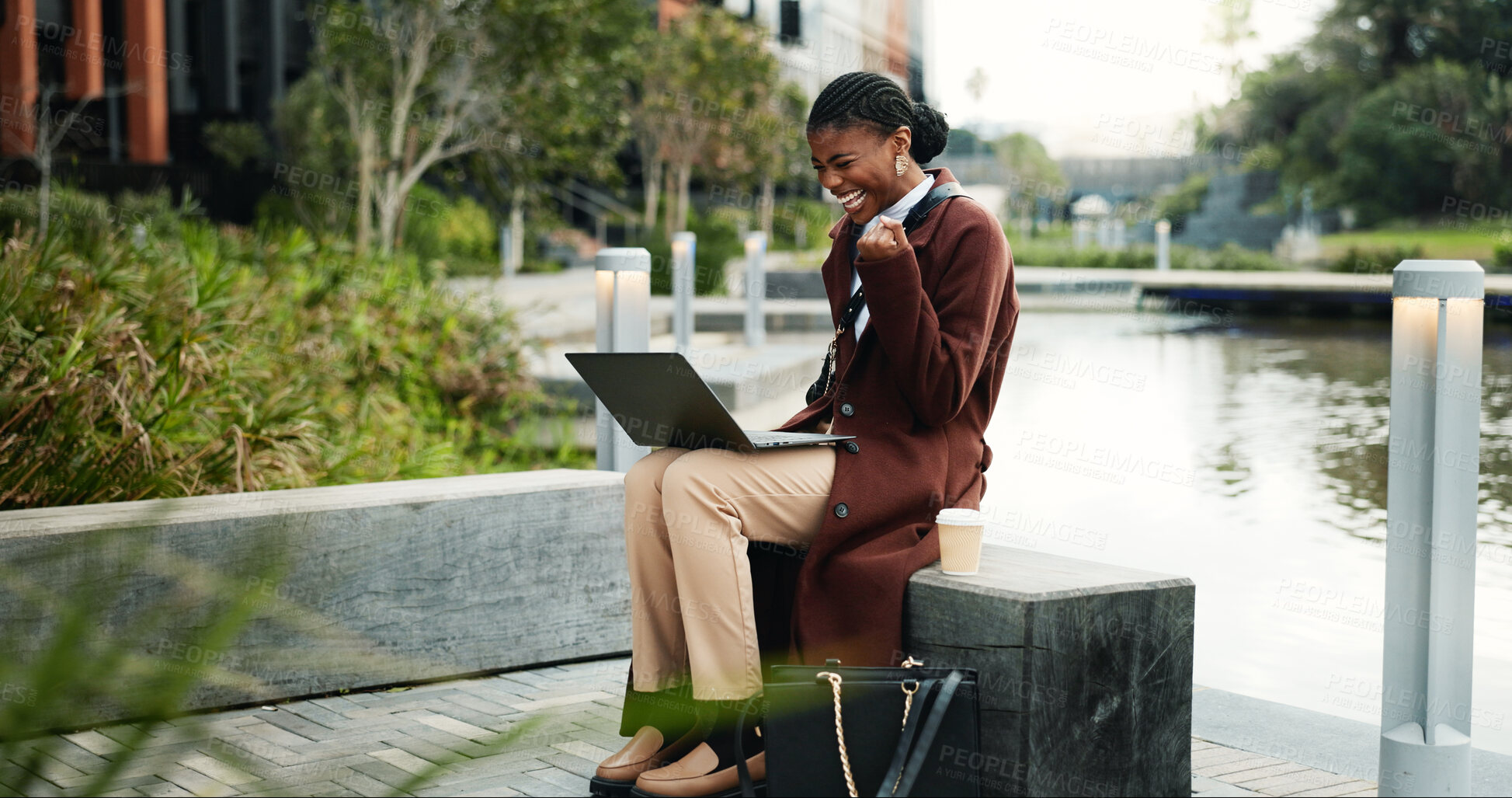 Buy stock photo Businesswoman, smile and celebration in city with laptop, remote work or success for copywriting job. Happy, black person or freelancer by canal with computer, fist pump or good news for SEO project.