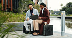 Meeting, discussion and business people in city with laptop, property listing and real estate planning. Realtor, team and check housing market in urban town with computer, website and collaboration.