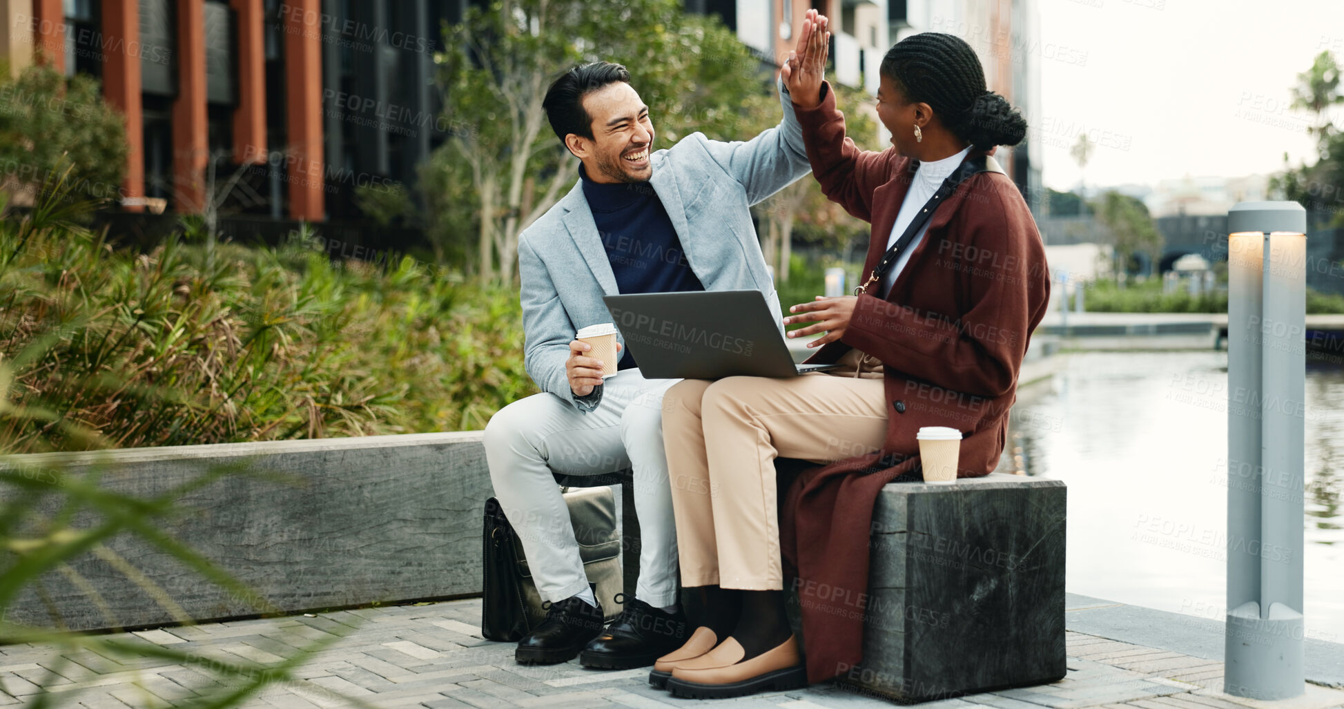 Buy stock photo Laptop, happy and business people in city with high five, remote work or success for email marketing. Team, partnership and celebration in urban town with computer, good news or advertising milestone