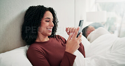 Buy stock photo Happy woman, phone and texting in bed with contact, relax and laugh at funny meme with break in home. Person, smile and sleeping man in morning or mobile app, video and social media in house