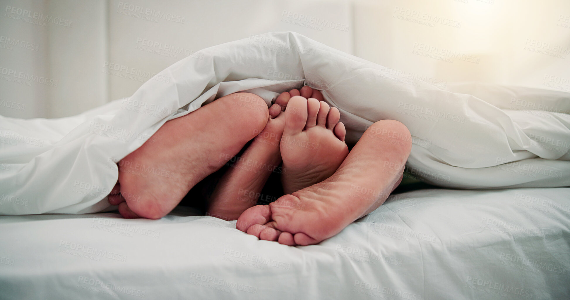 Buy stock photo Cuddle, sleeping and feet of couple in bed for resting, dreaming and relax together in home. Apartment, bedroom and people with blanket, duvet and barefoot for comfort, bonding and relationship