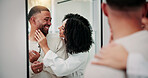 Happy couple, joke and laugh in bathroom at mirror with care, connection and bonding in home. Woman, man and playful with smile, touch or relationship with partner for morning routine at apartment