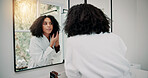 Woman, grooming and mirror with haircare in bathroom for hair treatment, hygiene or spa day. Female person, salon and lens flare with reflection, beauty or dermatology for morning routine in home