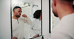 Man, couple and brushing teeth in bathroom with mirror, dental hygiene and morning routine together. Married people, toothbrush and reflection in home with oral health, cleaning mouth and wellness.