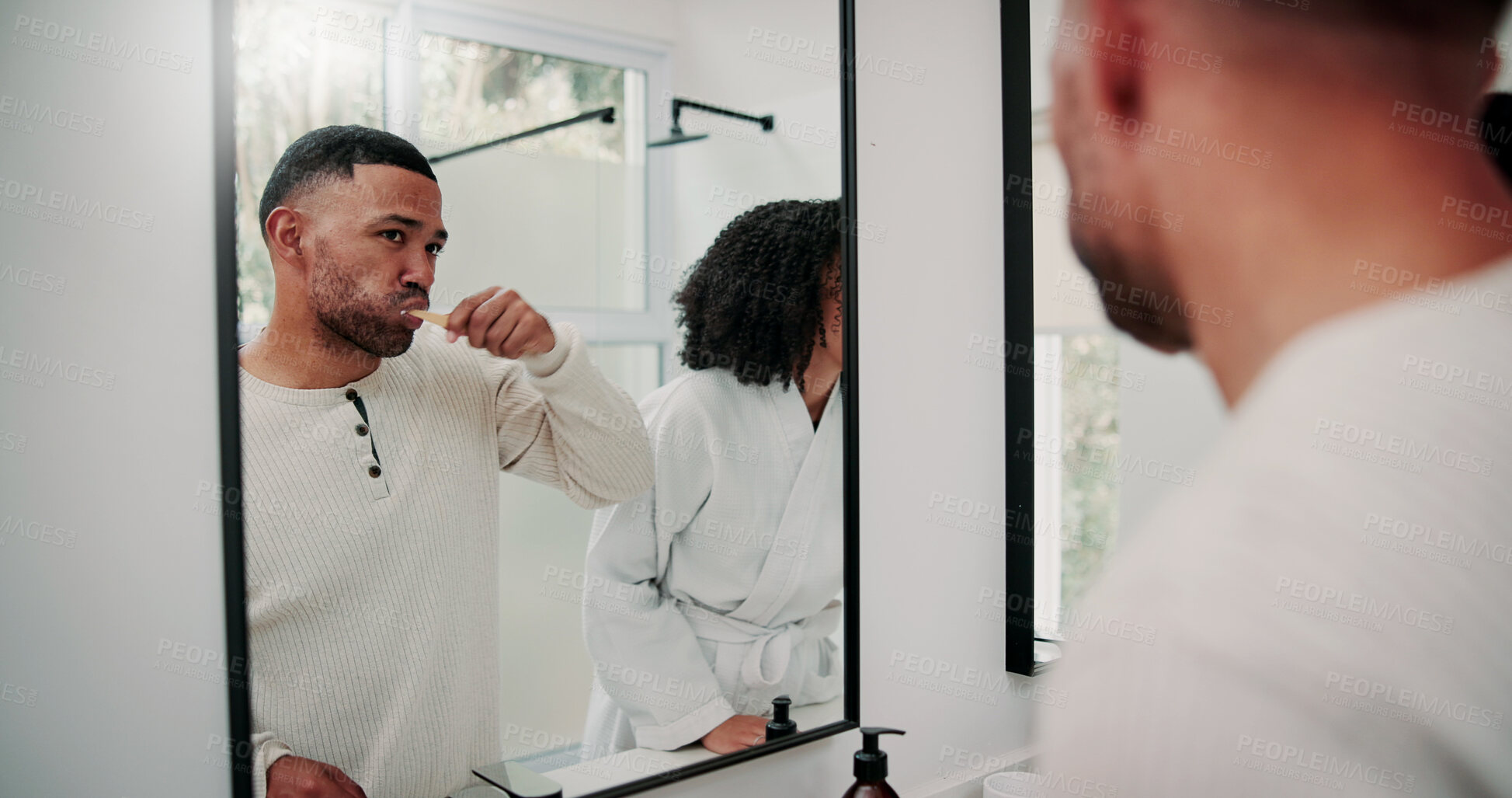 Buy stock photo Man, couple and brushing teeth in bathroom with mirror, dental hygiene and morning routine together. Married people, toothbrush and reflection in home with oral health, cleaning mouth and wellness.